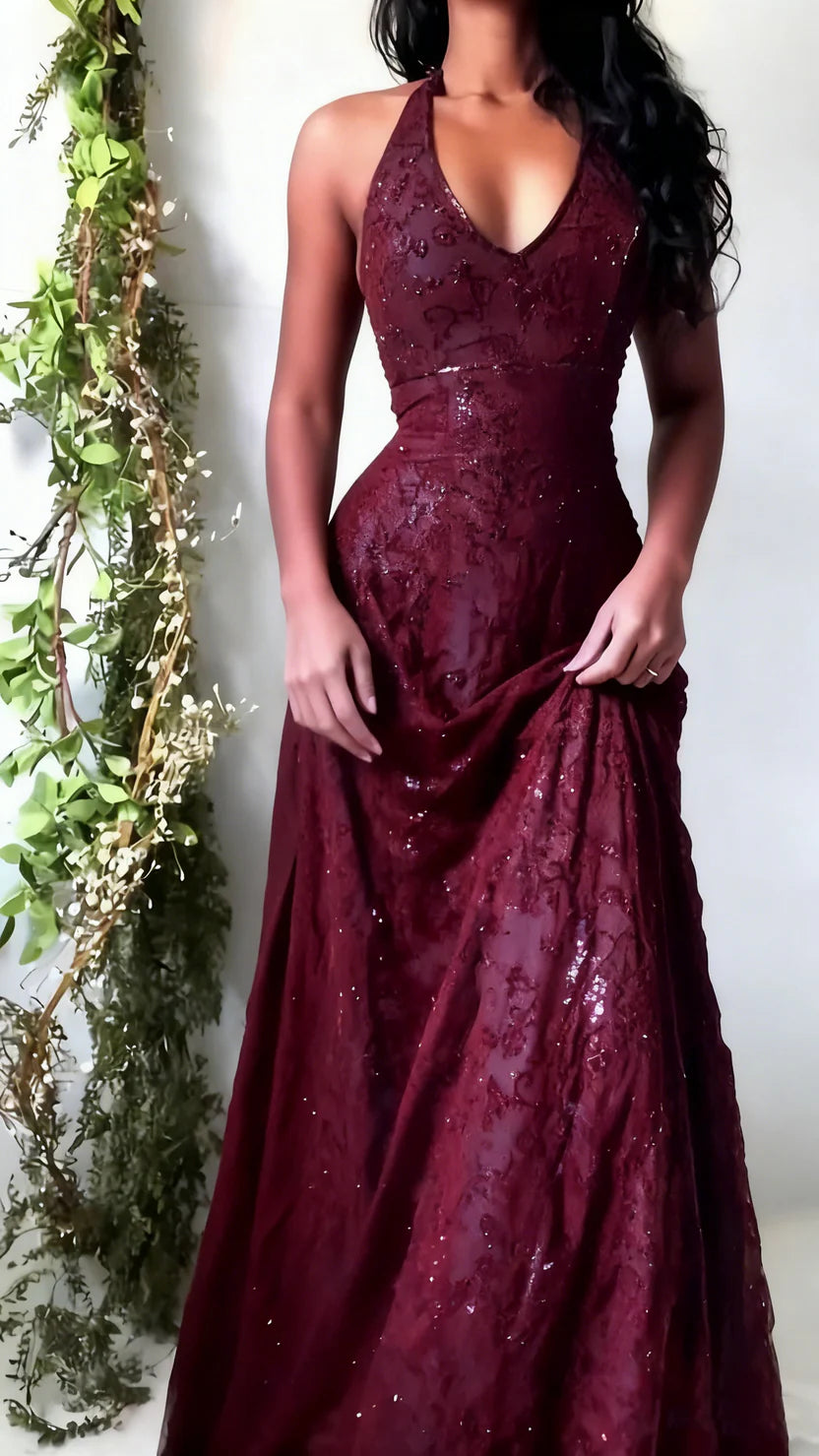 Burgundy evening gown with sequin detailing worn by a person, against a white background.